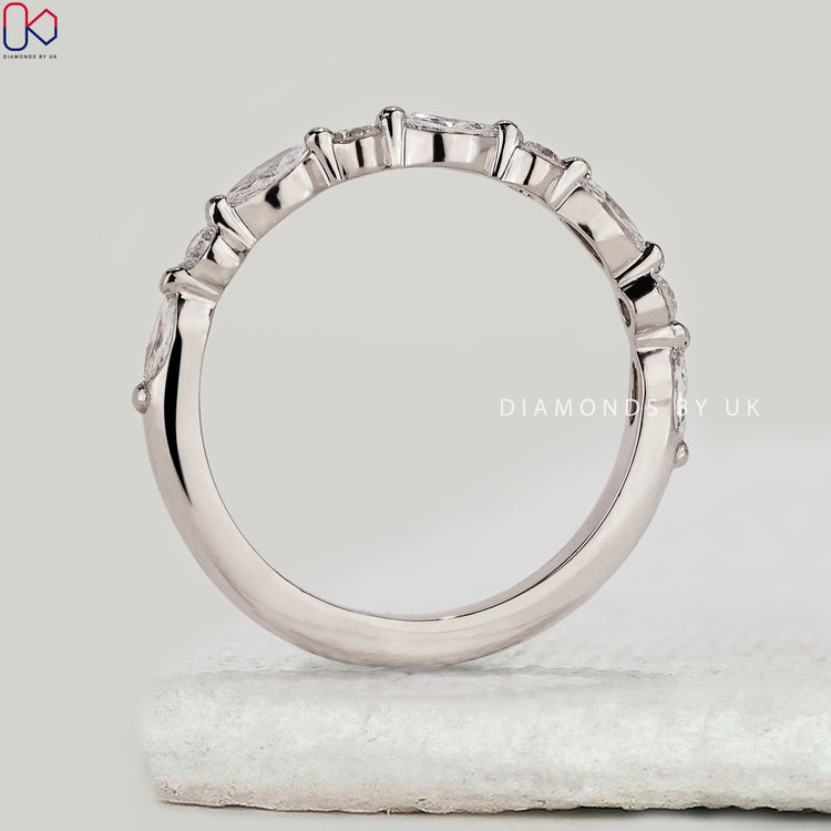 Marquise and round diamond band in half eternity style.
