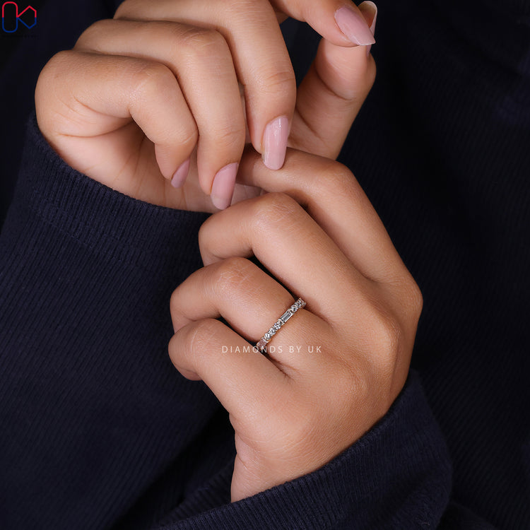 Baguette and round cut wedding band with prong set diamonds.