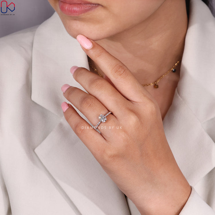 Cushion cut diamond ring with pavé band style.