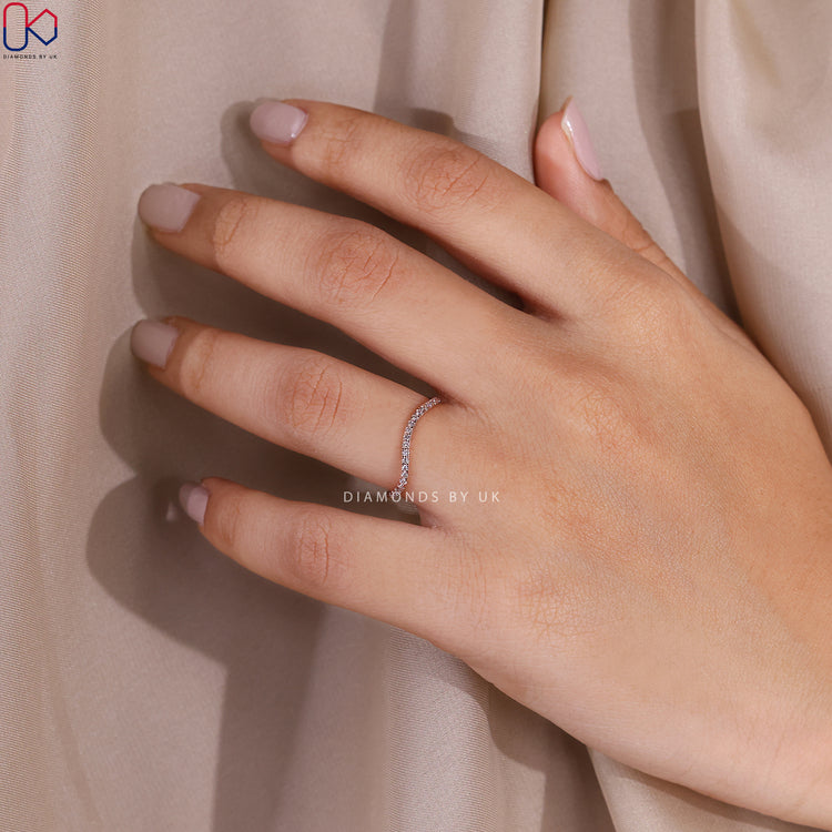 Round cut lab grown diamond band with wave design.
