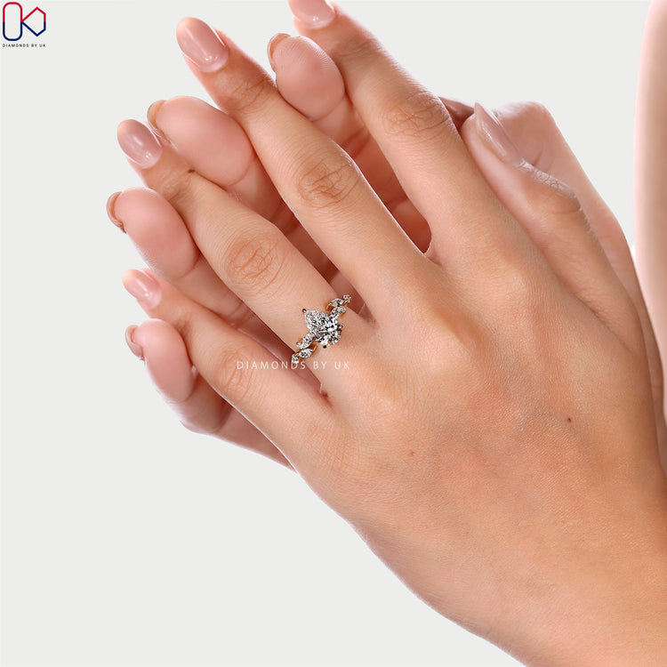 Pear cut diamond ring with three claw prong setting.
