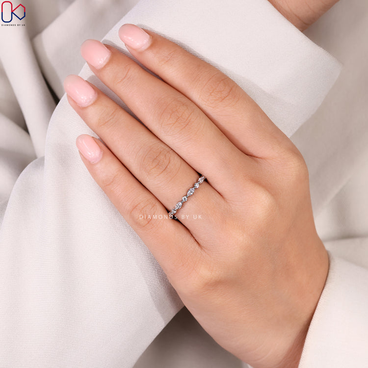 Marquise and round diamond band with shared prongs.
