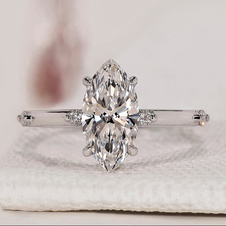 Handmade marquise diamond ring with distance pavé style.