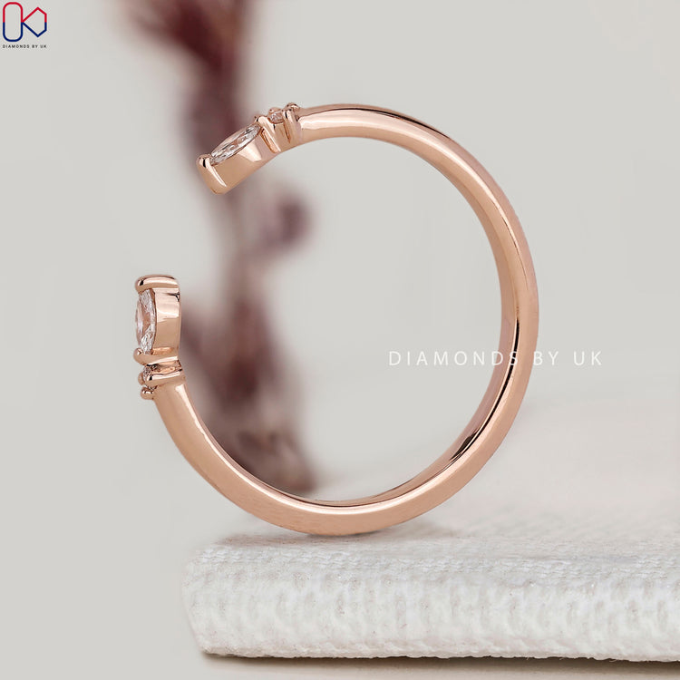 Open gap diamond band with marquise and round stones.