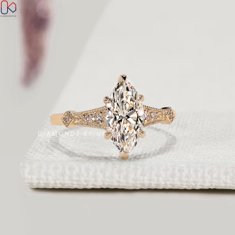 Marquise diamond ring with hidden halo and split shank.
