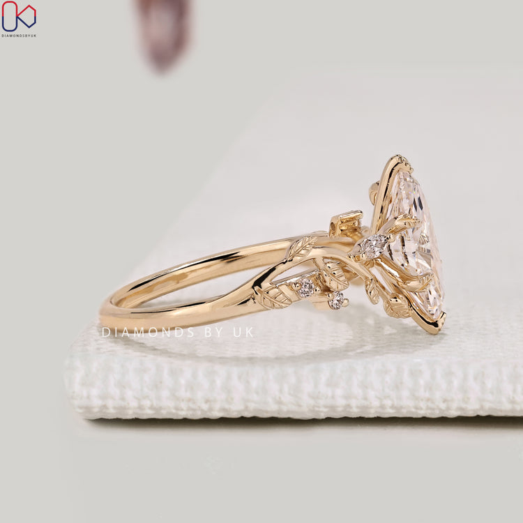 Lab grown marquise diamond ring with round side stones.
