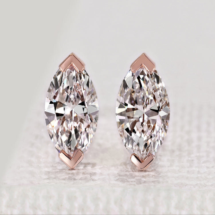 Marquise diamond stud earrings with V prong setting.