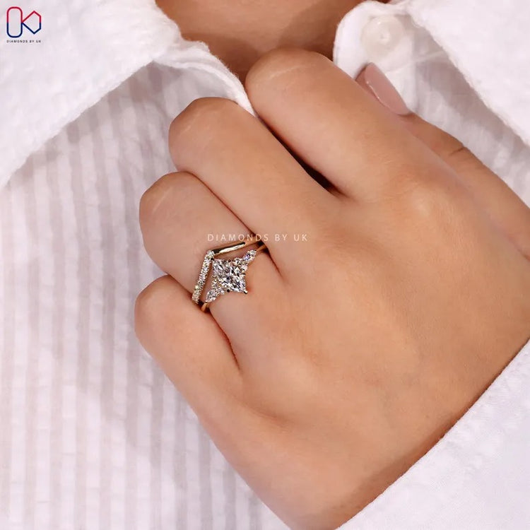 Marquise diamond ring with muse setting and side stones.