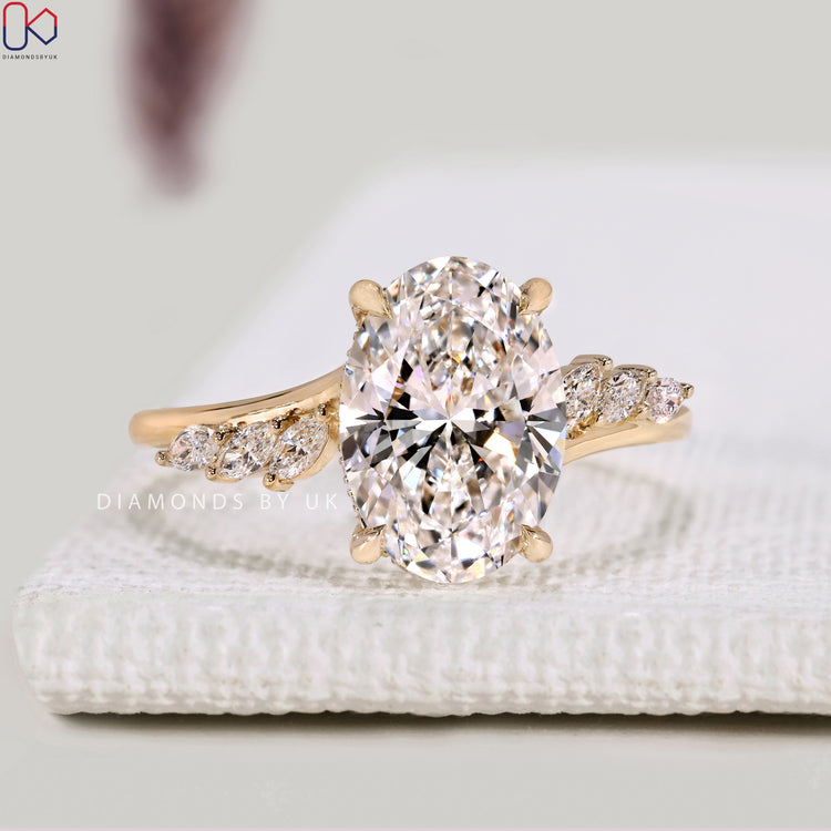 Lab grown oval diamond ring with four claw prongs.