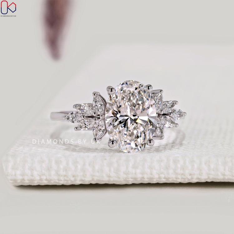 Oval diamond ring with marquise stones and muse setting.
