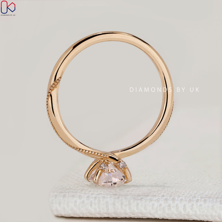 Round cut ring with hidden stones and milgrain
