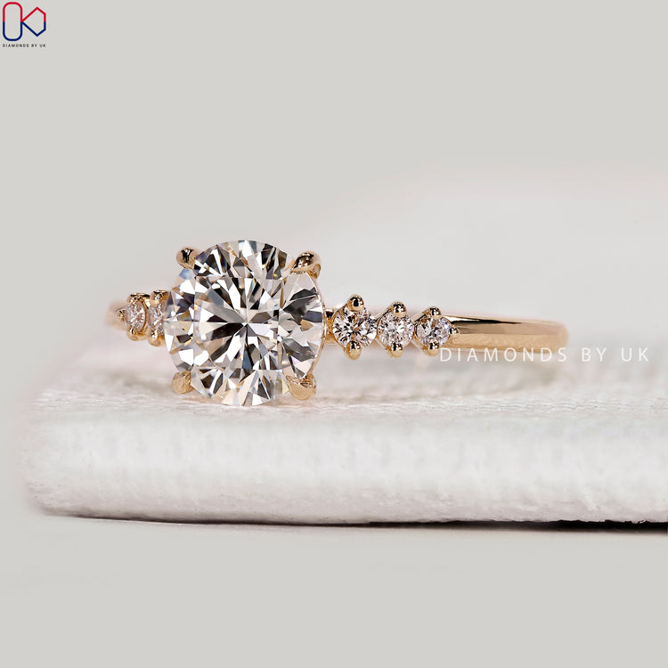 Round cut lab grown diamond ring with side stones.