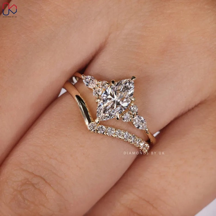 Marquise engagement ring with round diamond wedding band.