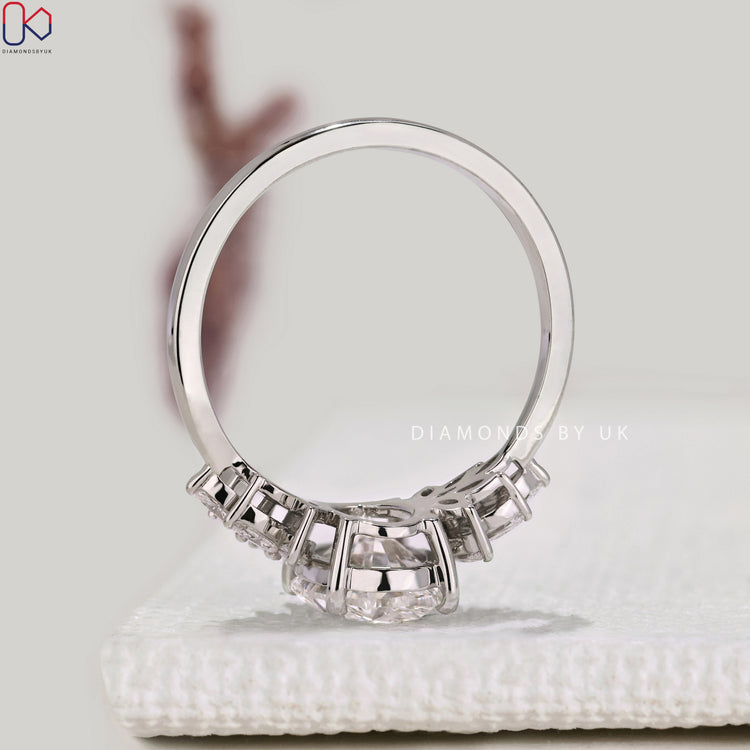 IGI certified oval diamond ring with marquise stones.
