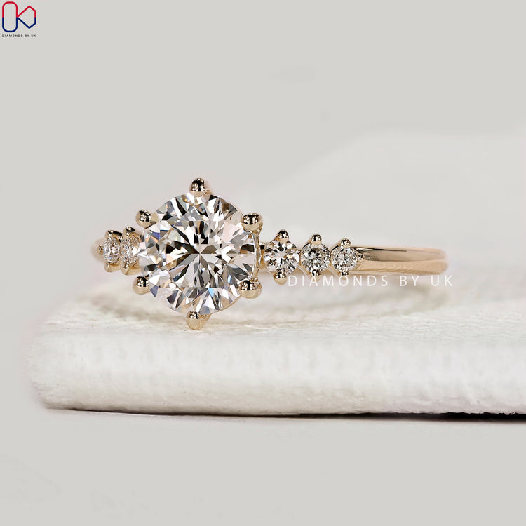 Round cut lab grown diamond ring with side stones.