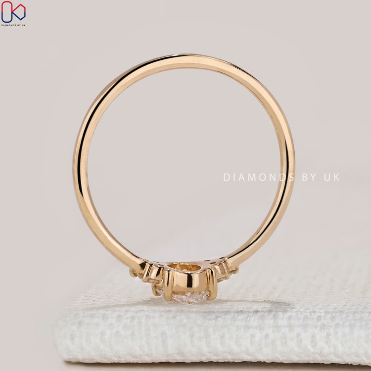 Oval cut ring with round diamond side stones.