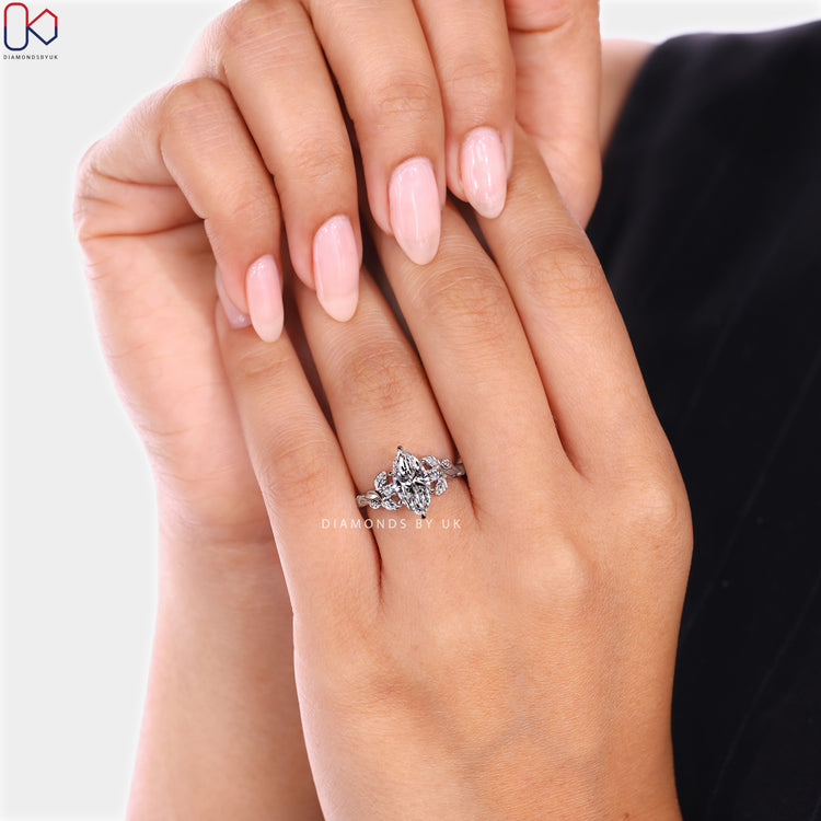 Diamondsbyuk marquise diamond ring with round side stones.
