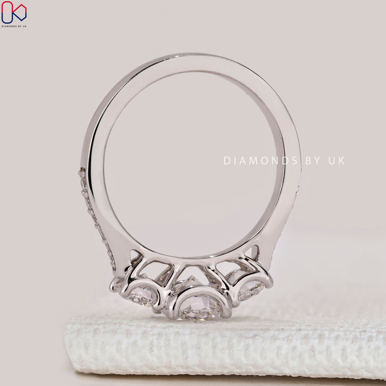 Round cut ring with pavé and tapered shank.