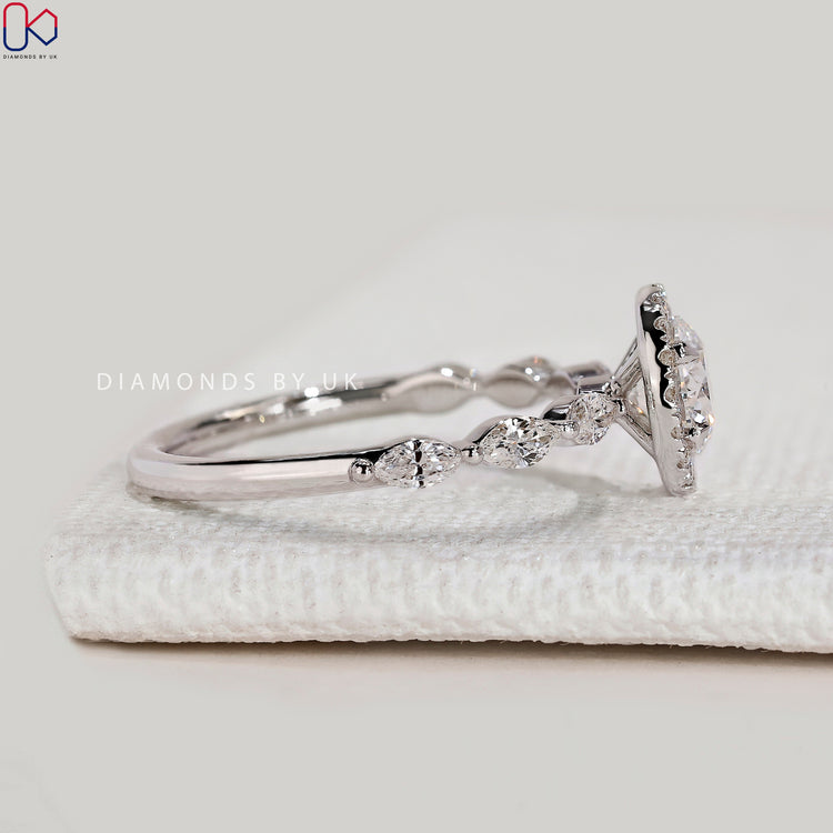 Handmade round cut ring with four claw prongs.