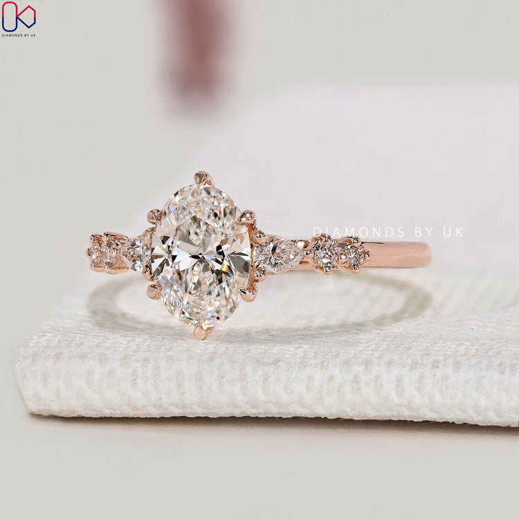 Lab grown oval diamond ring with side stone style.
