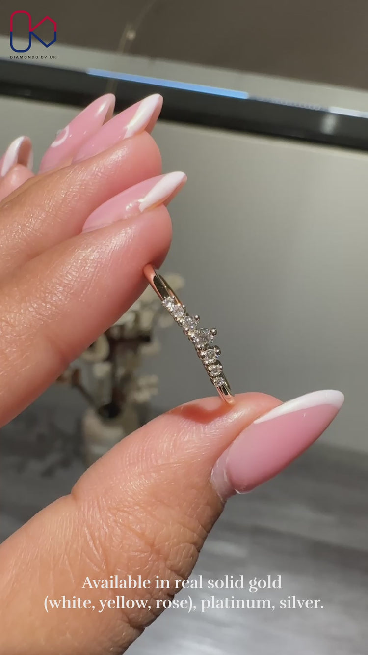 Round cut diamond band set in a prong style on yellow gold.
