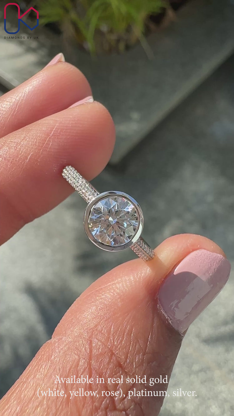 Two sided pave set engagement ring featuring a round diamond.
