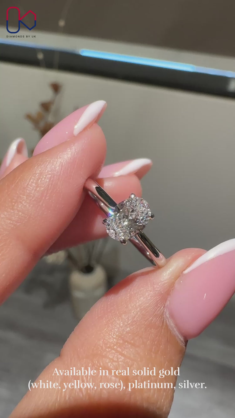 Oval Solitaire Ring featuring a stunning oval cut diamond in a white gold cathedral setting.

