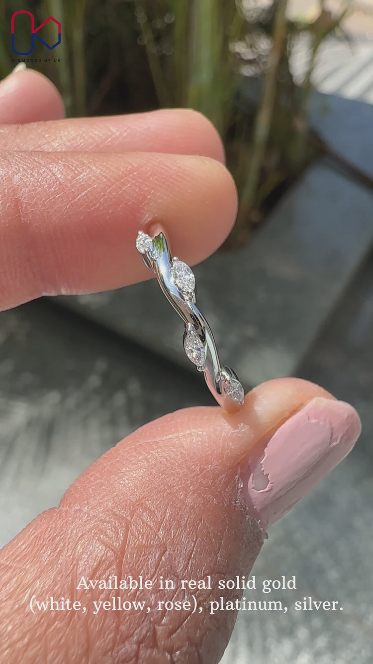 Stunning marquise wedding band featuring delicate diamond accents.