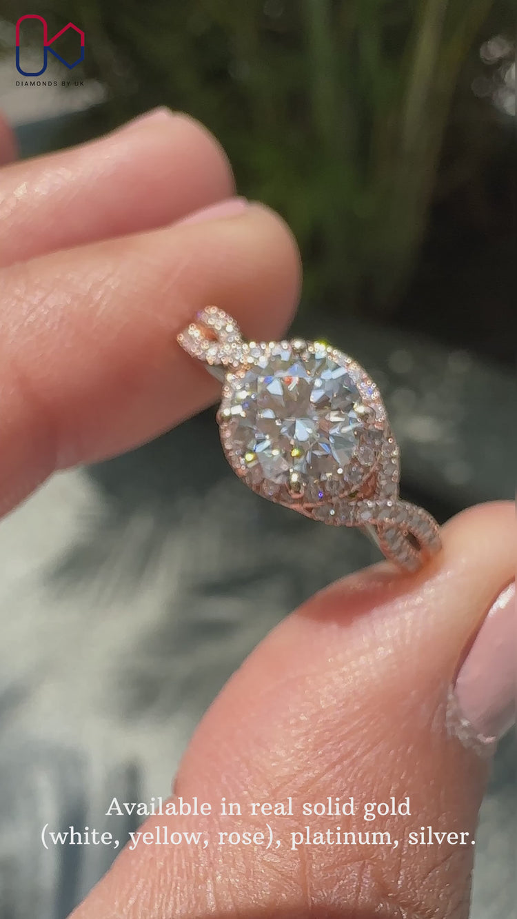 Round cut diamond ring with twisted halo design.
