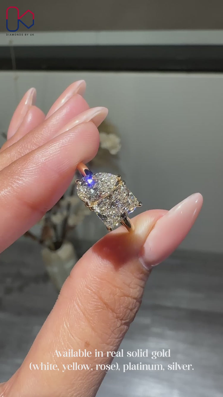 Radiant and pear cut engagement ring in yellow gold.

