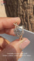 White gold ring with twisted pave and halo setting.

