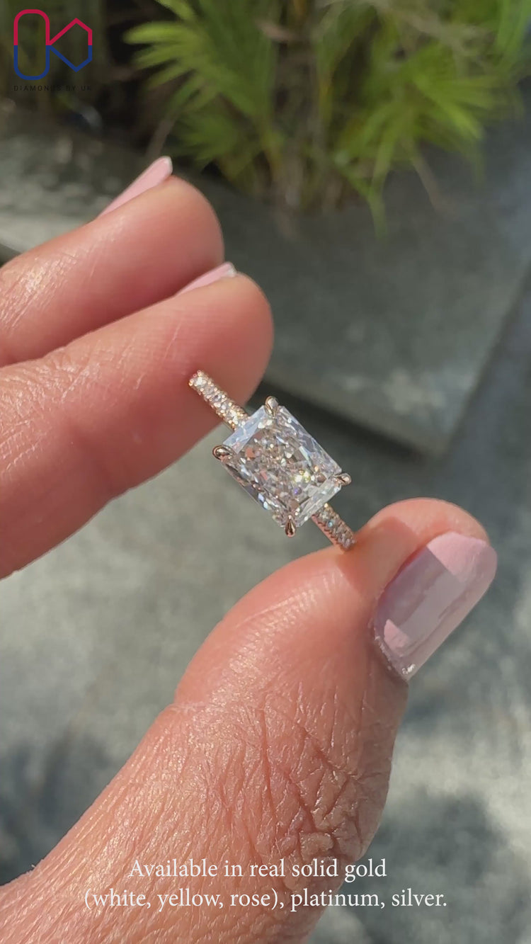 East to west ring design featuring a radiant cut diamond.
