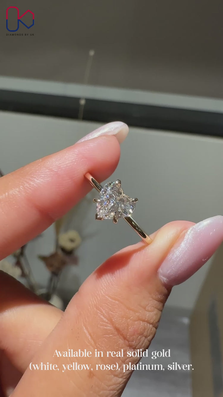 Solitaire setting heart shaped diamond engagement ring.
