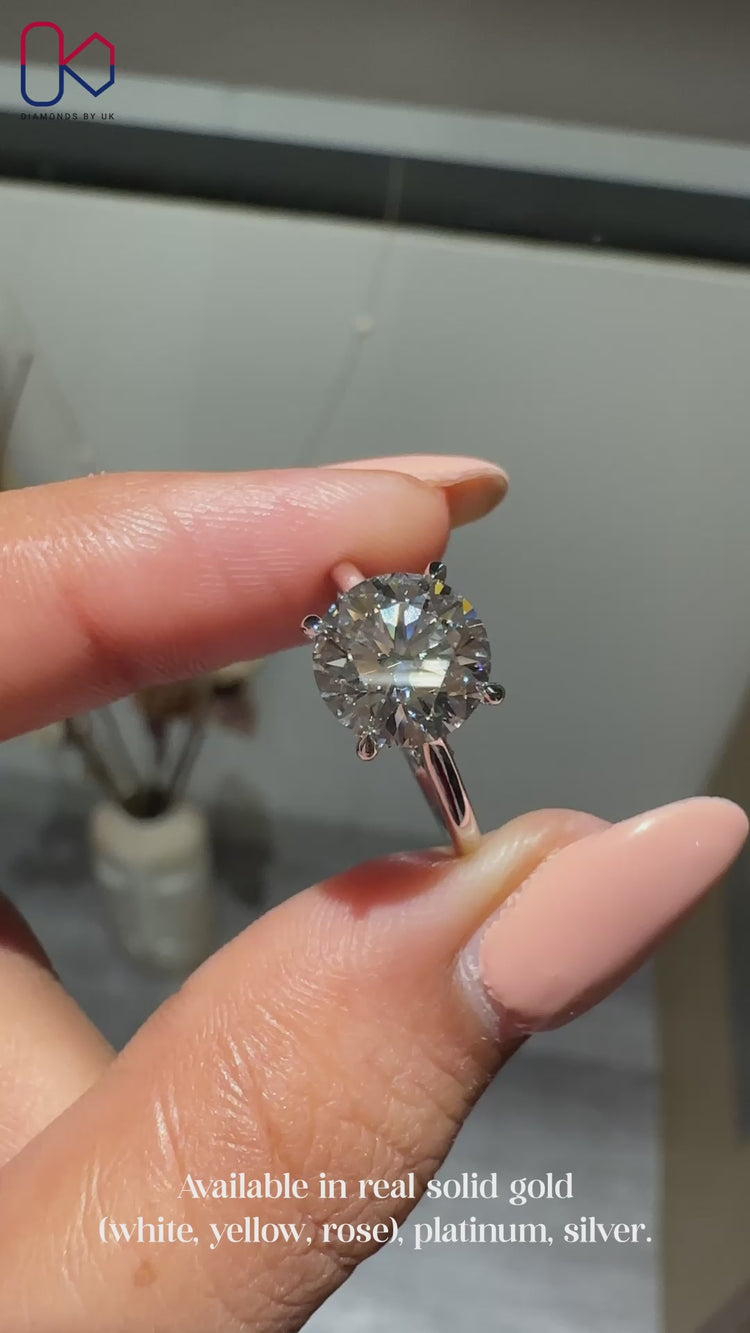 Round engagement ring with bridge accent style.