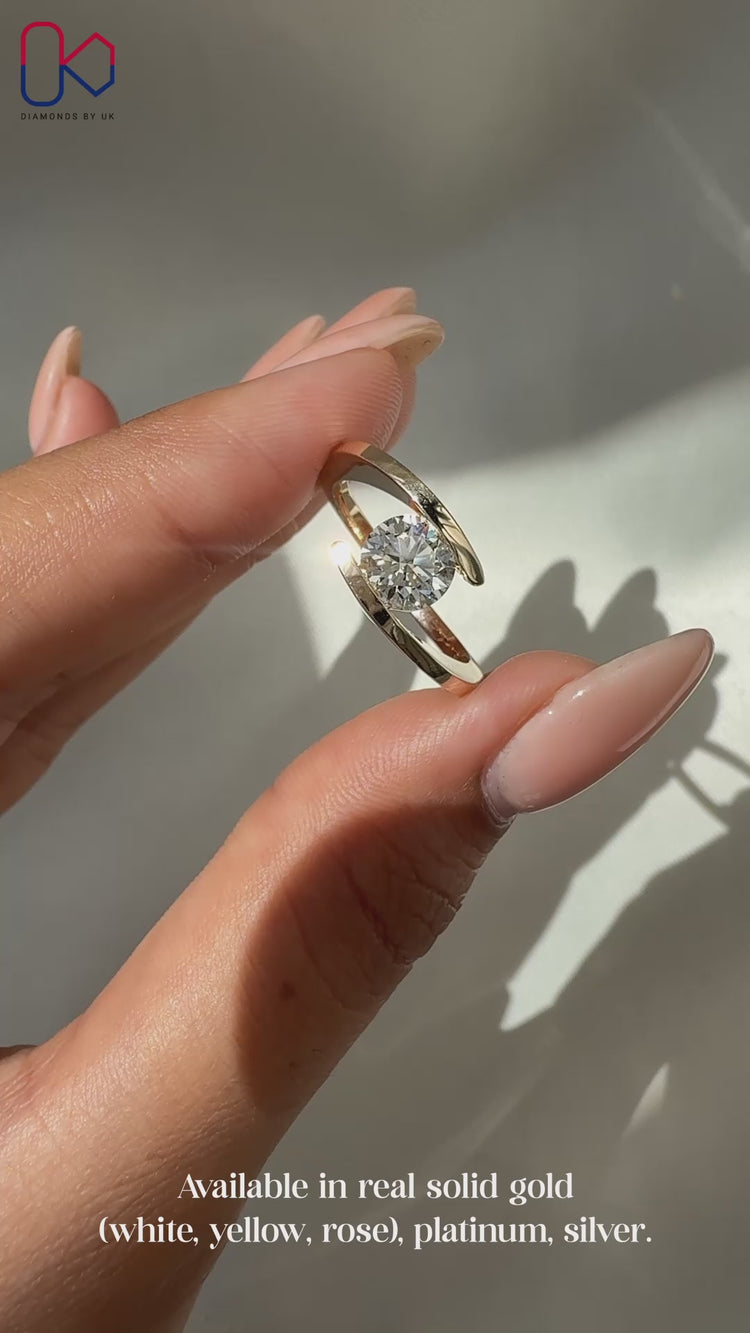 Round diamond engagement ring made with handmade detail and clean yellow gold lines.