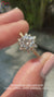 Round cut diamond ring in a stunning cluster halo design.
