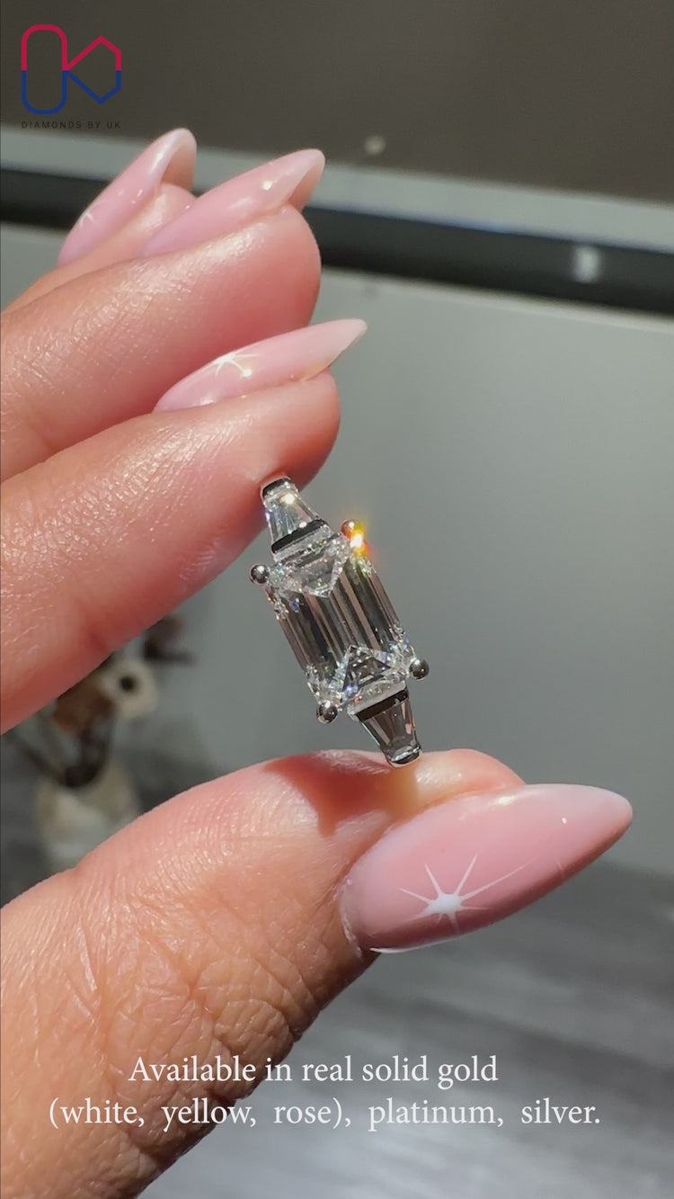 Three-stone diamond ring with sparkling stones.
