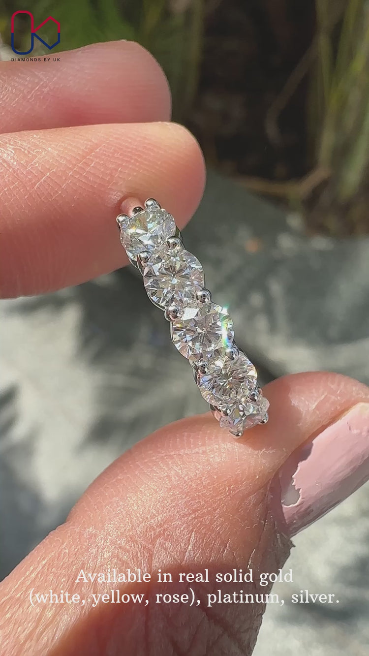 Round diamond wedding band crafted with shared prong settings for added brilliance.
