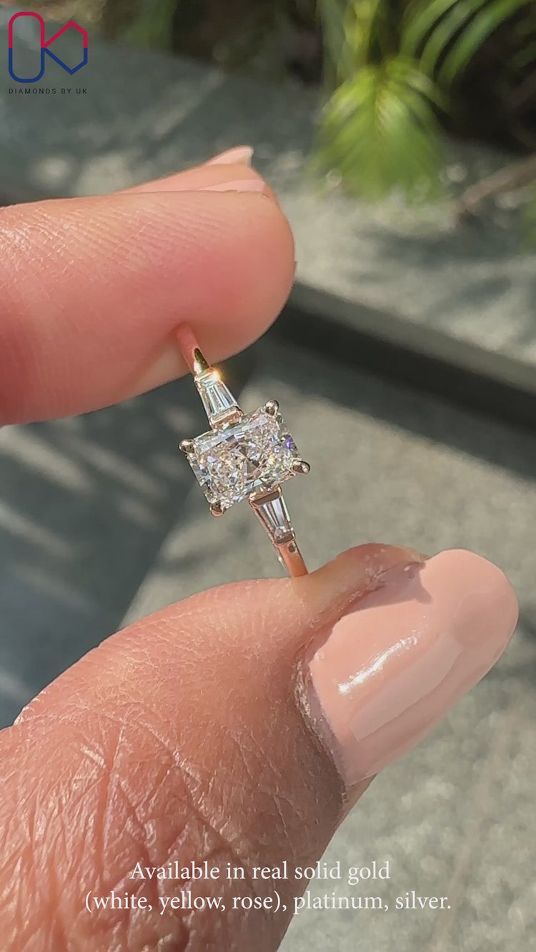 Radiant cut diamond ring set in a beautiful side stone engagement ring.
