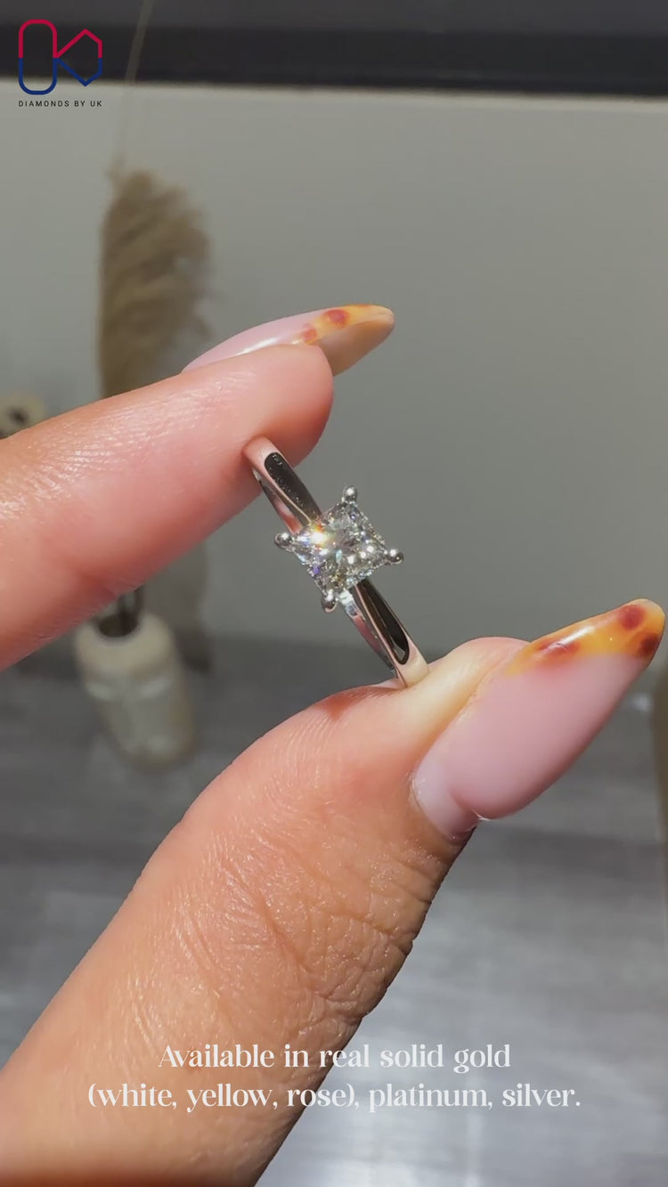 Solitaire setting princess cut diamond ring.
