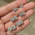 Diamondsbyuk round diamond studs with four prongs.  
