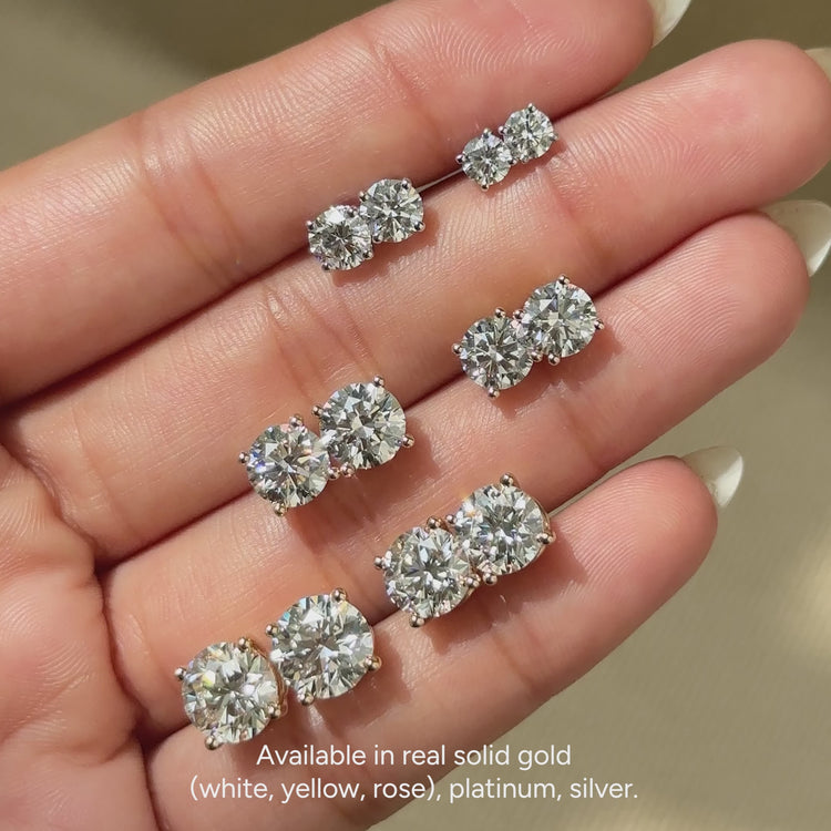 Diamondsbyuk round diamond studs with four prongs.  
