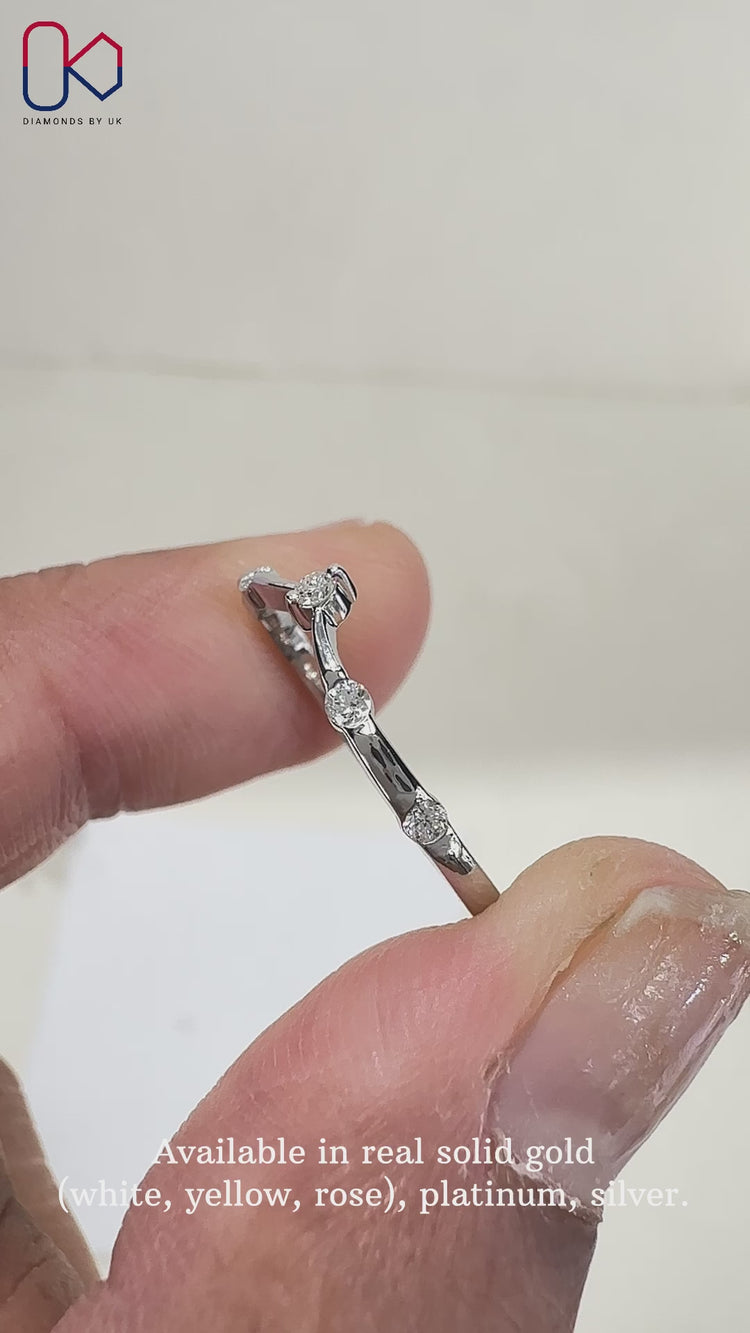 Stunning curved diamond wedding band featuring sparkling diamonds.