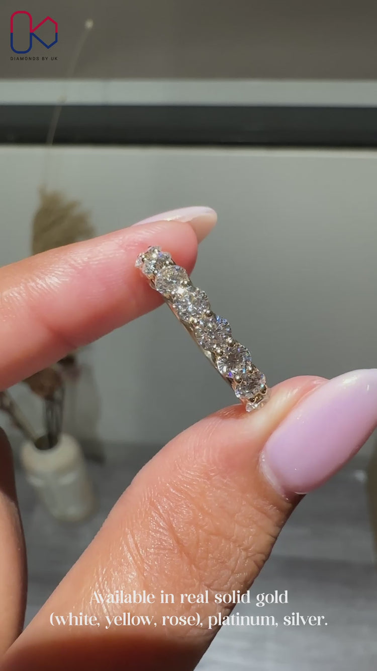 Round diamond wedding band in yellow gold.
