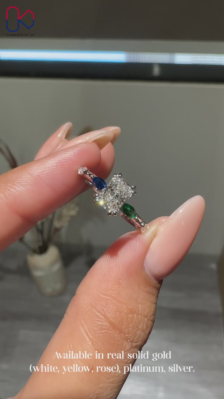 Topaz green marquise diamond with round side stones.
