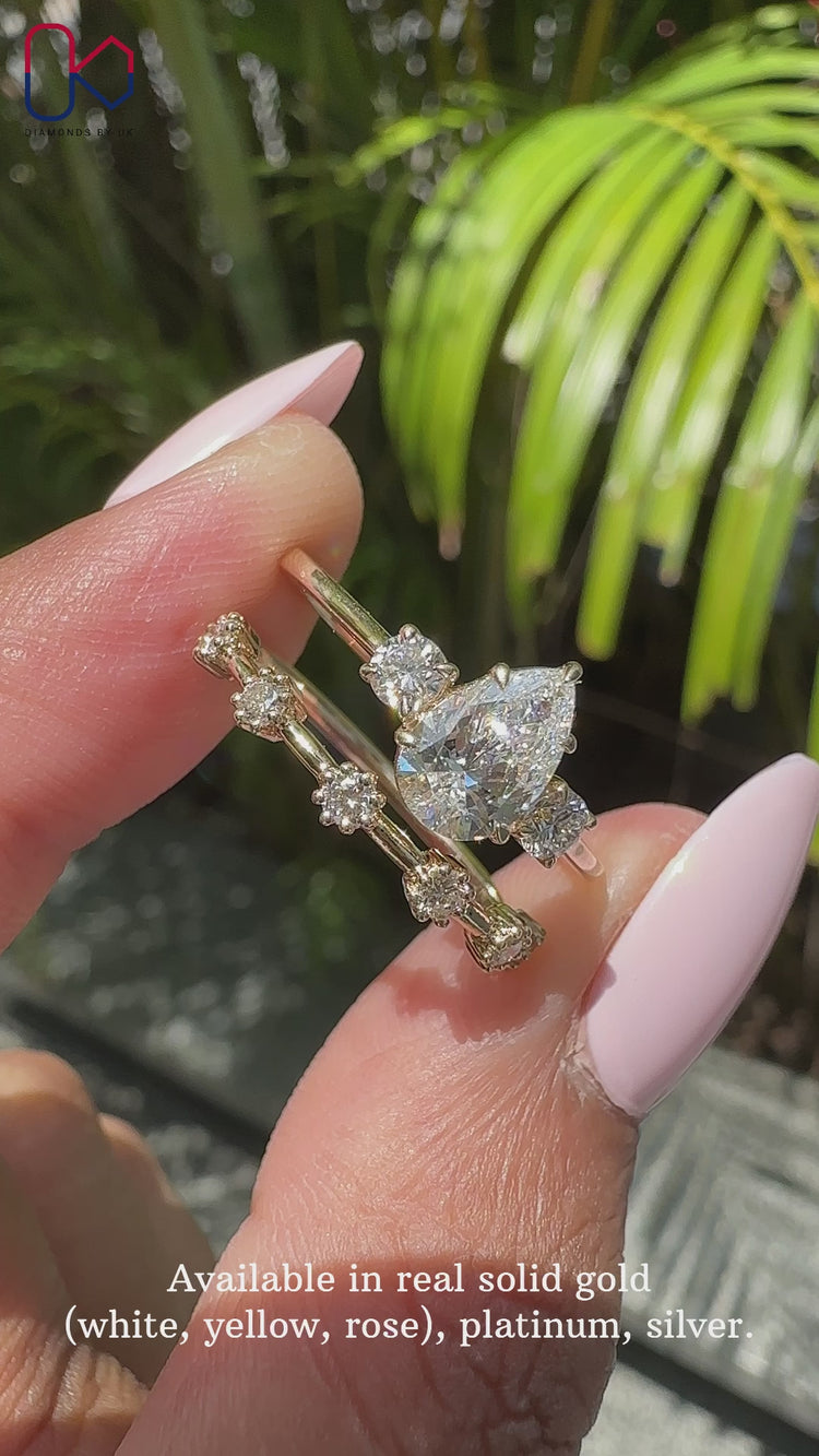 Pear engagement ring with wedding band featuring a pear cut diamond.
