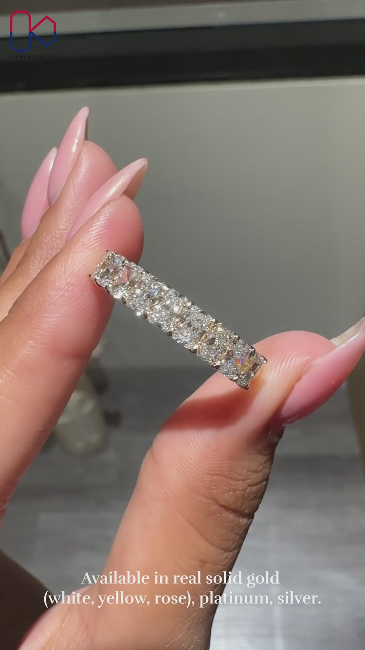 Half eternity wedding band featuring radiant cut lab grown diamonds.
