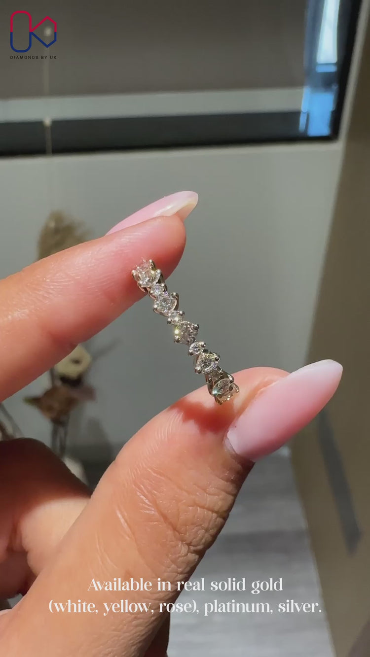 Round diamond wedding band with half eternity design.
