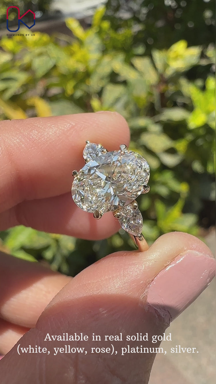 Oval and pear diamond engagement ring with a unique design.

