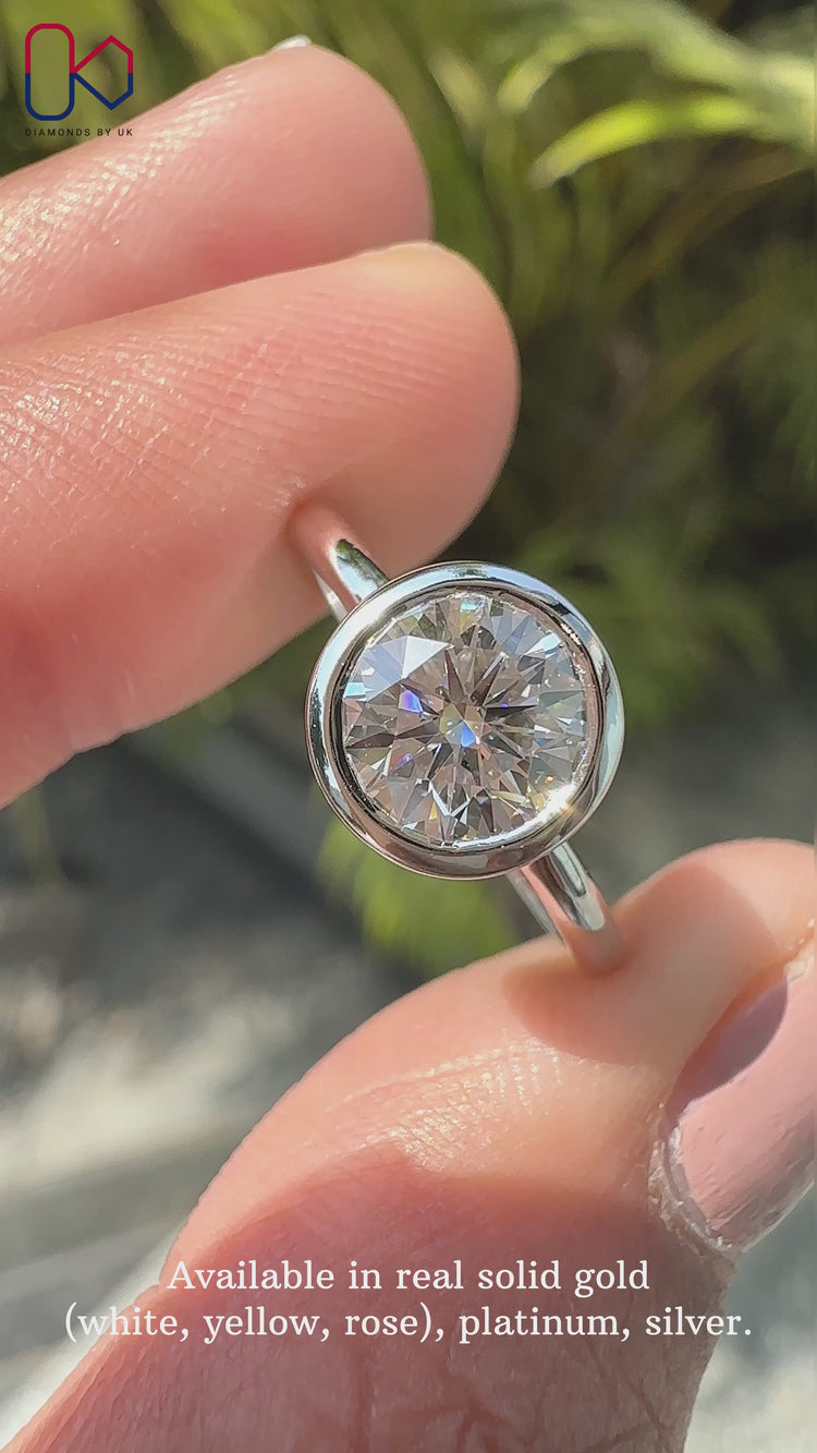 Bezel setting ring with a stunning round diamond engagement ring for a modern, elegant look.